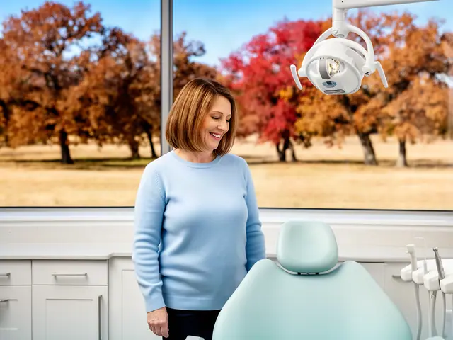 A dentist standing beside a dental chair.